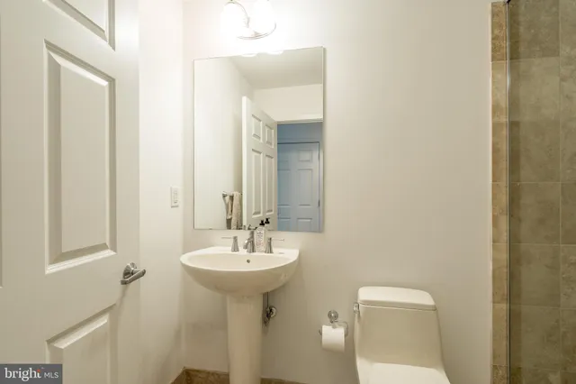 a bathroom with a sink a toilet and mirror