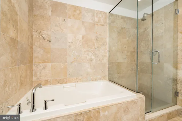 a bathroom with a window and a shower