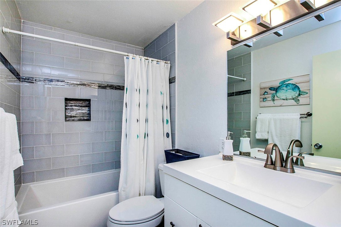 822 Beach Road Sanibel, FL 33957 - Photo 19 of 35 a bathroom with a sink toilet and shower