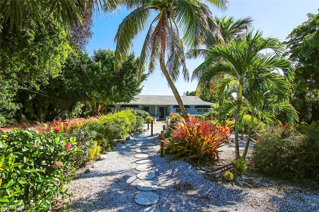 822 Beach Road Sanibel, FL 33957 - Photo 32 of 35 a view of a garden with a house and a garden
