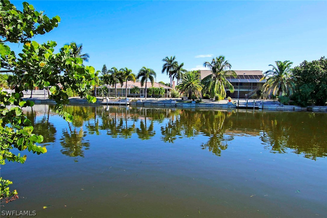822 Beach Road Sanibel, FL 33957 - Photo 4 of 35 a view of a lake with a house in the background