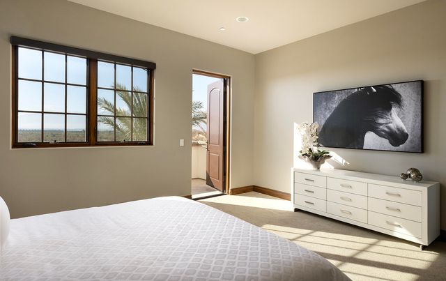 a bathroom with a granite countertop toilet sink and mirror