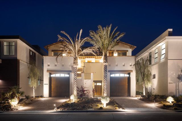 a front view of a residential houses with yard