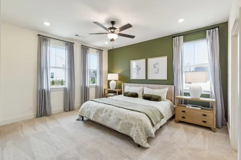 a bedroom with a large bed and a chandelier