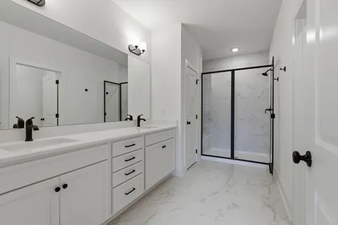 a spacious bathroom with a double vanity sink mirror and double