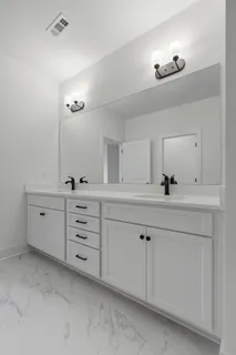 a bathroom with a sink vanity and mirror