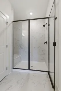 a bathroom with a glass shower door