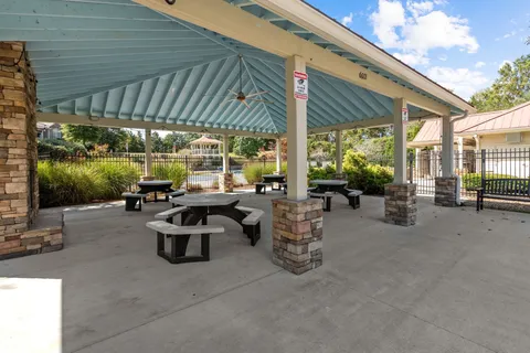 a building outdoor space with patio furniture and potted plants