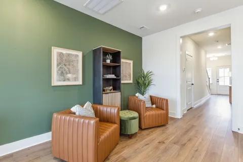 a living room with furniture and a wooden floor