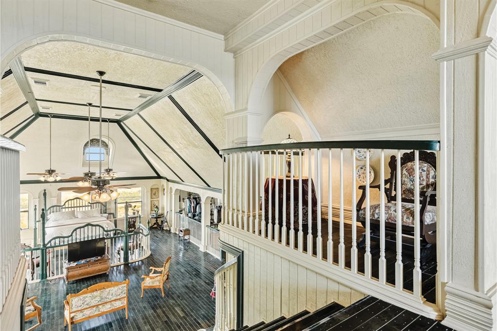 10771 6th Highway Meridian, TX 76665 - Photo 35 of 40 Hallway with ornamental molding, arched walkways, and wood finished floors