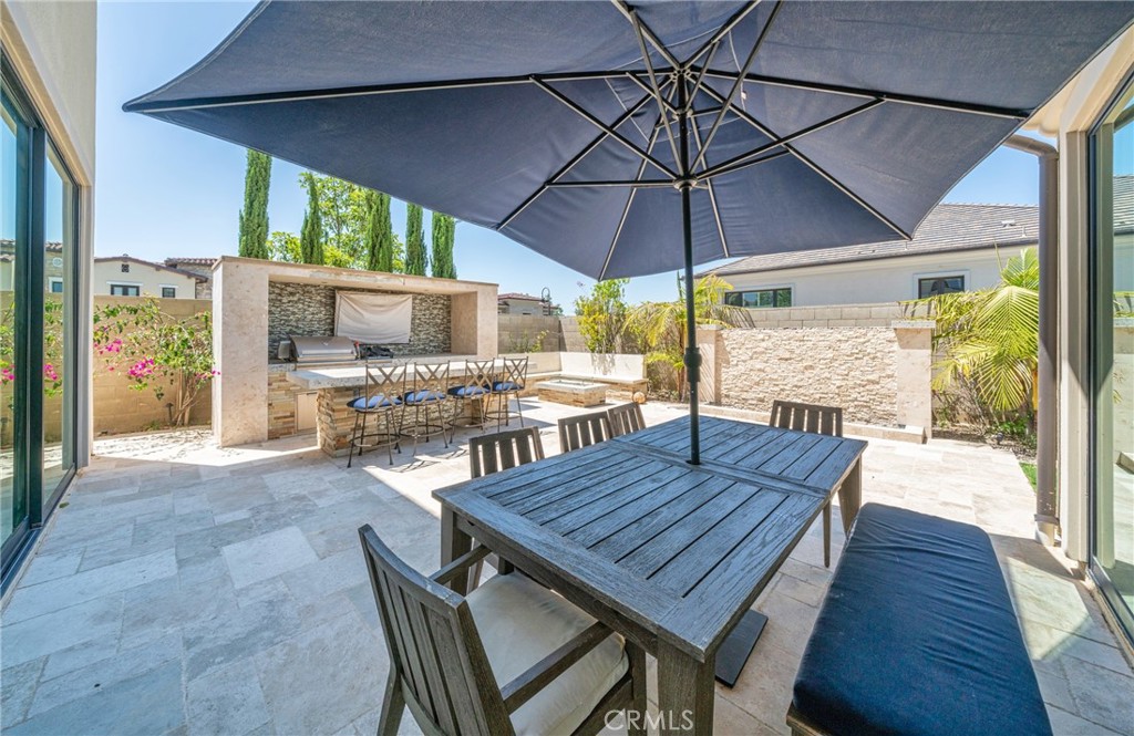 52 Eider Run Irvine, CA 92618 - Photo 19 of 46 a view of a patio with a table chairs and a umbrella
