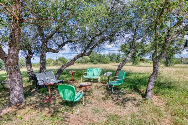 a view of a chairs and table in the yard