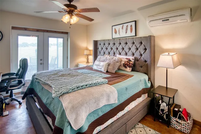 a bedroom with a bed and a chandelier