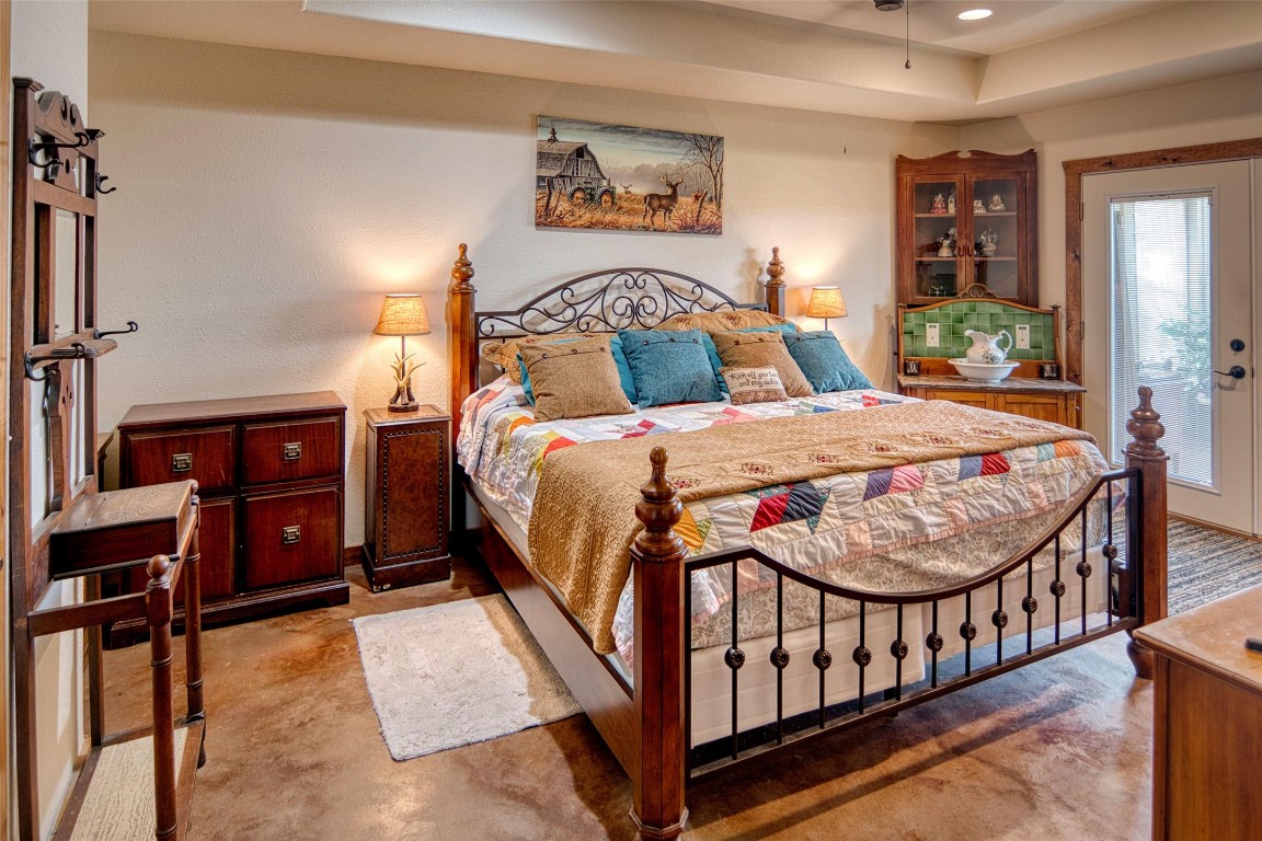 12119 Highway 29 Llano, TX 78643 - Photo 8 of 40 a bedroom with a bed and wooden floor