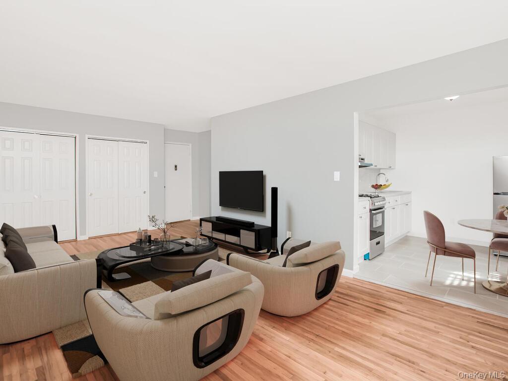 6535 Broadway, Unit 5C Bronx, NY 10471 - Photo 4 of 12 a living room with furniture wooden floor and a flat screen tv