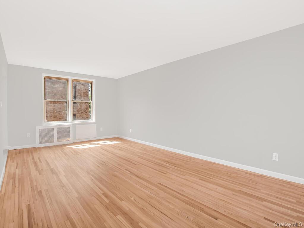6535 Broadway, Unit 5C Bronx, NY 10471 - Photo 7 of 12 wooden floor in an empty room with a window