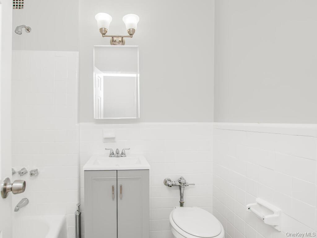 6535 Broadway, Unit 5C Bronx, NY 10471 - Photo 10 of 12 a bathroom with a sink toilet and mirror