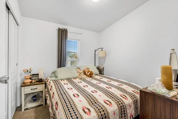 a bedroom with a bed and a dresser