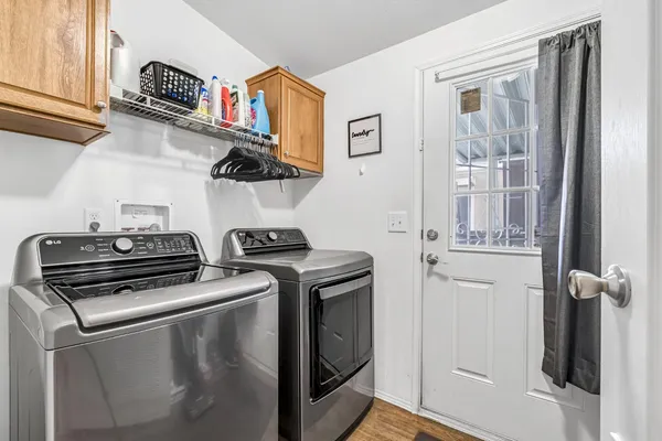 a bedroom with a bed next to a window with a flat screen tv