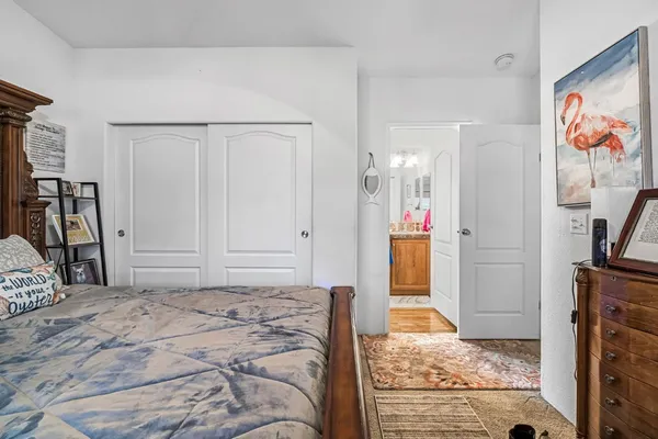 a bathroom with a granite countertop sink a toilet and a mirror