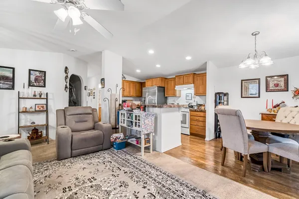 a living room with furniture and kitchen view