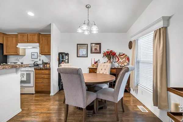 a view of a dining room with furniture window and wooden floor