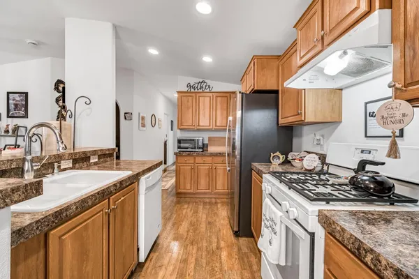 a kitchen with a sink stove and cabinets