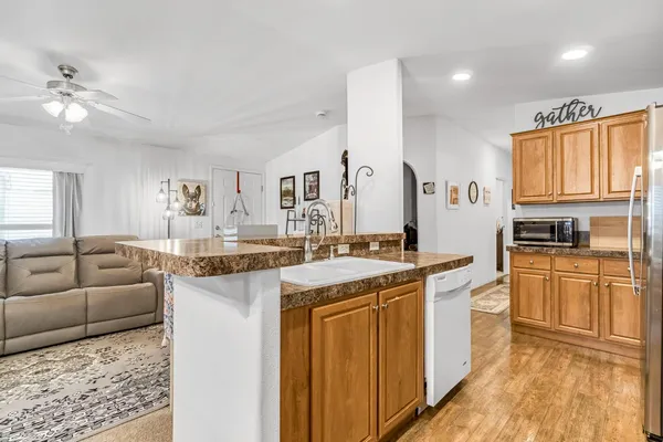 a kitchen with stainless steel appliances granite countertop a sink and cabinets