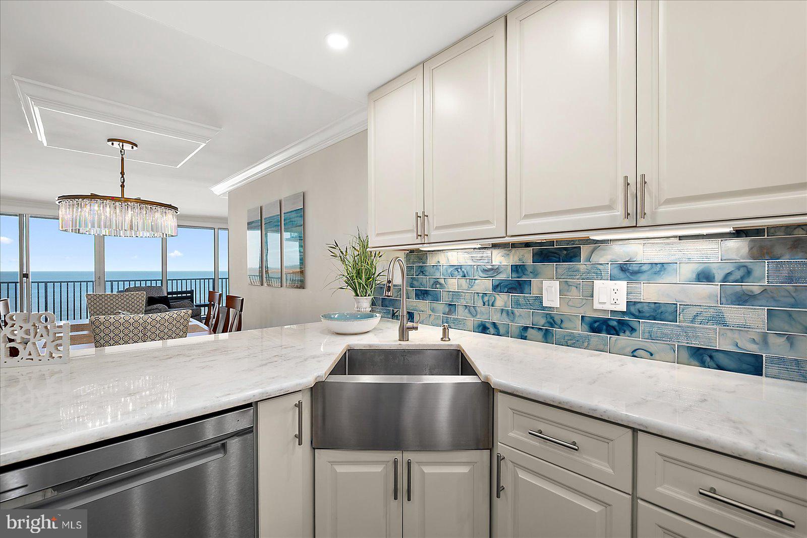 903 North Edgewater House Road Bethany Beach, DE 19930 - Photo 11 of 43 a kitchen with kitchen island granite countertop a sink a center island and cabinets