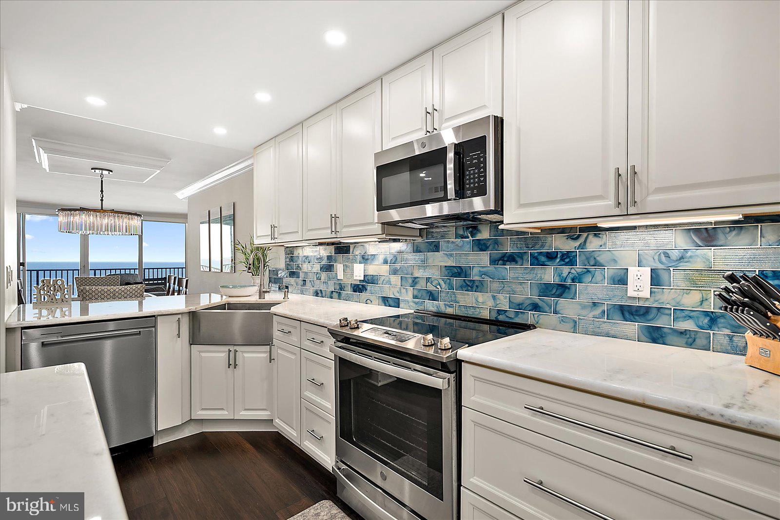 903 North Edgewater House Road Bethany Beach, DE 19930 - Photo 14 of 43 a kitchen with stainless steel appliances granite countertop a sink a stove and cabinets