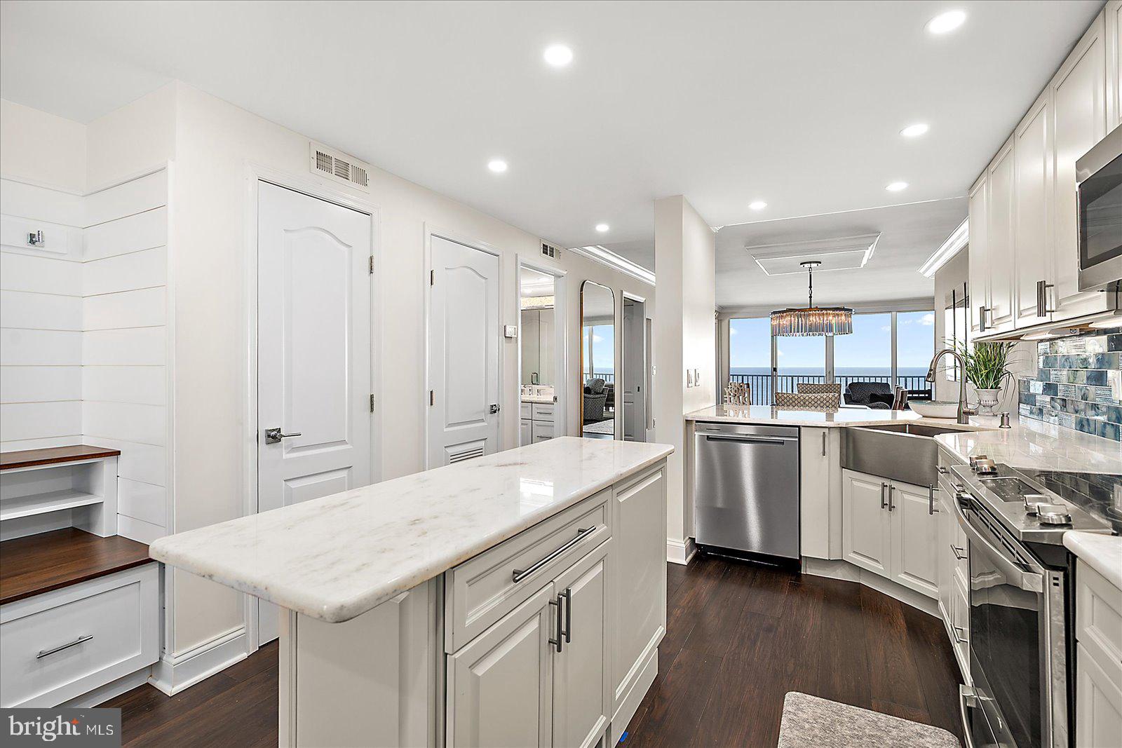 903 North Edgewater House Road Bethany Beach, DE 19930 - Photo 15 of 43 a kitchen with white cabinets appliances and sink
