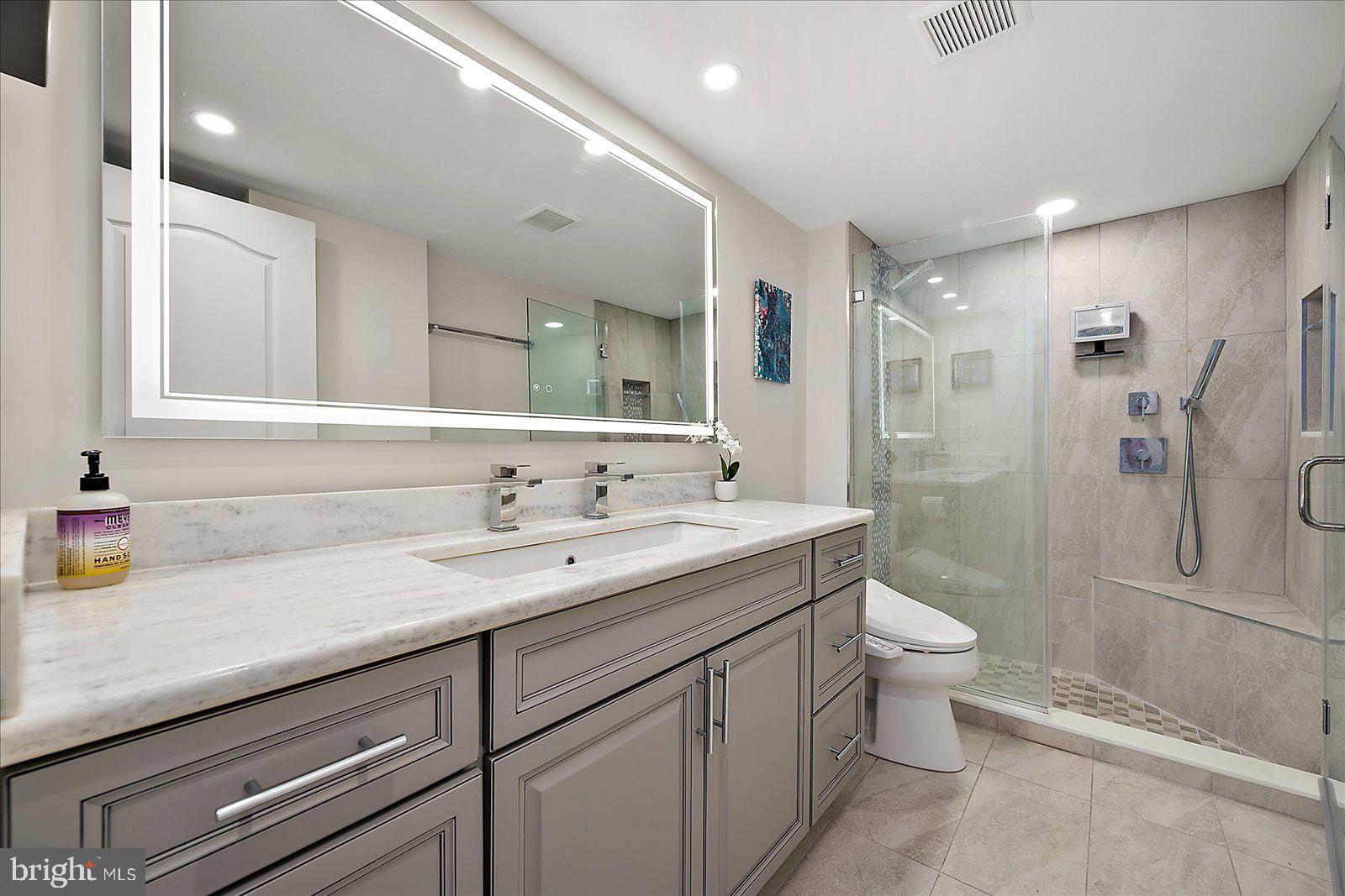 903 North Edgewater House Road Bethany Beach, DE 19930 - Photo 21 of 43 a bathroom with a granite countertop sink toilet and shower