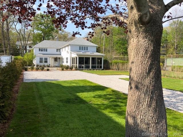 63 Middle Beach Road Madison, CT 06443 - Photo 1 of 1 a front view of a house with a yard table and chairs