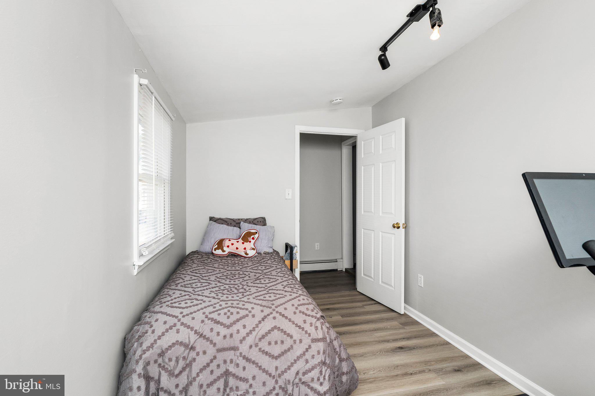 831 Conte Avenue Brick, NJ 08724 - Photo 18 of 27 a bedroom with a bed and wooden floor