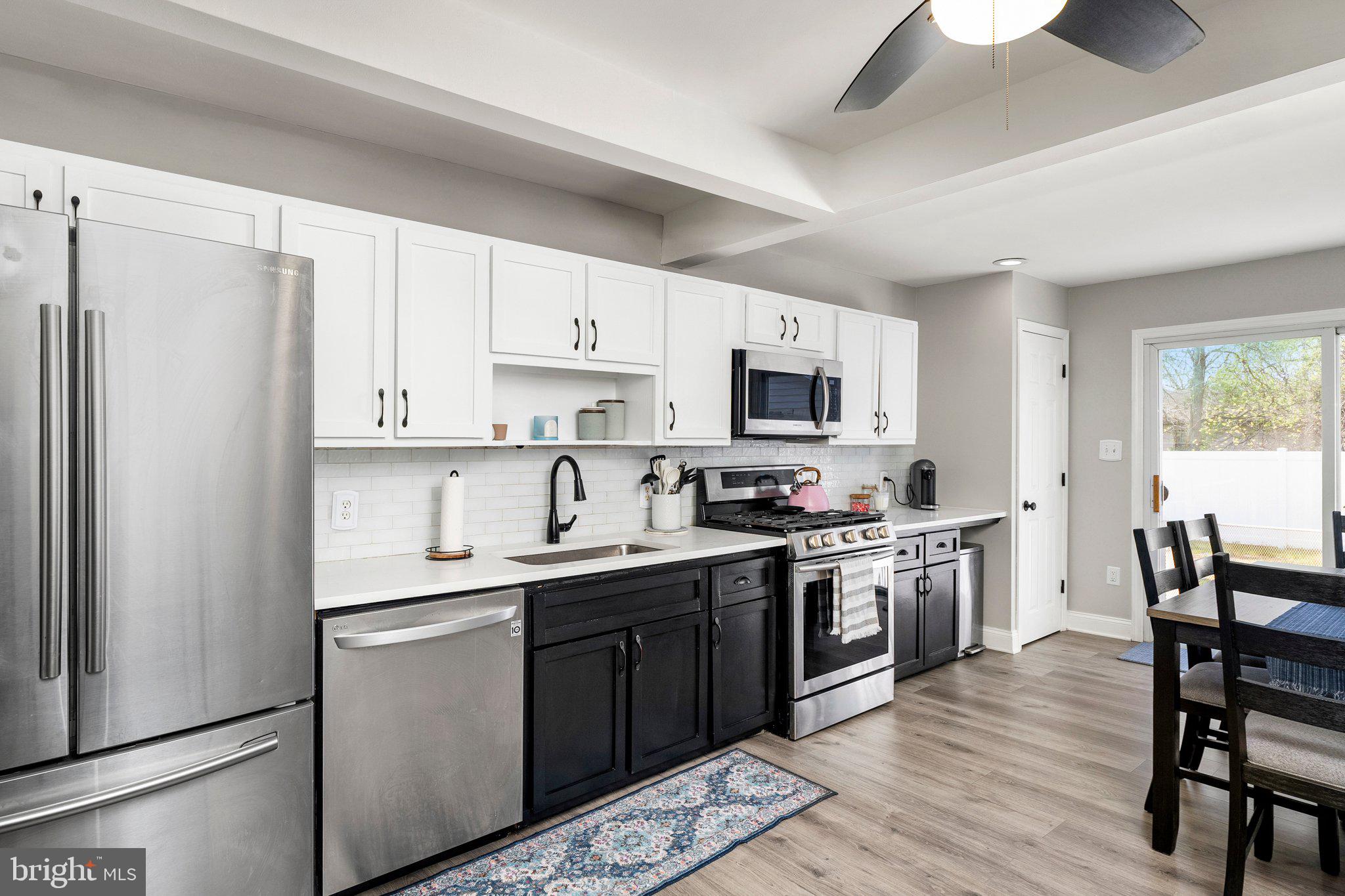 831 Conte Avenue Brick, NJ 08724 - Photo 8 of 27 a kitchen with white cabinets stainless steel appliances and a center island