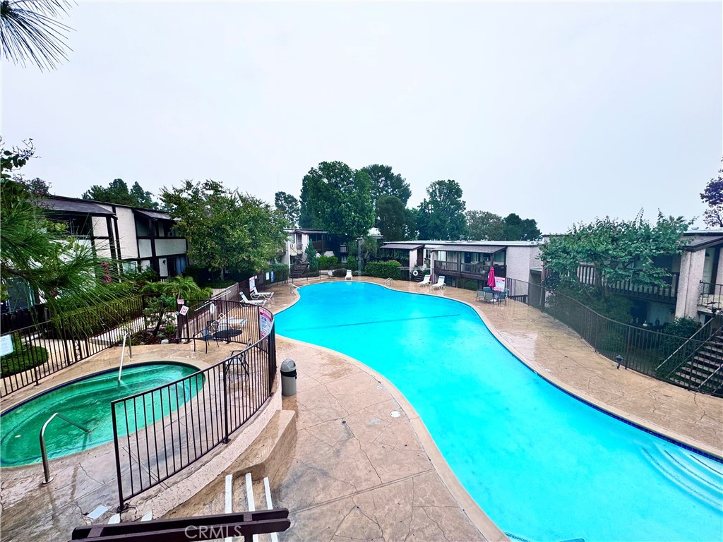 346 Miraleste Drive, Unit 301 San Pedro, CA 90732 - Photo 17 of 22 a view of a swimming pool with a patio and a yard