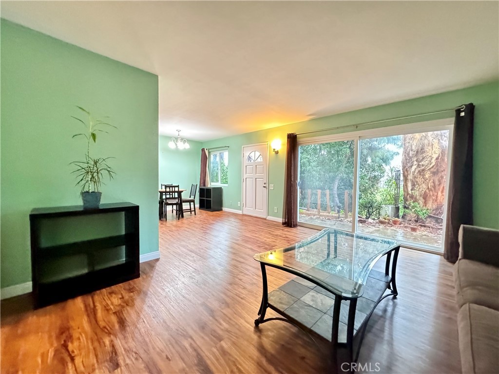 346 Miraleste Drive, Unit 301 San Pedro, CA 90732 - Photo 2 of 22 a living room with furniture a fireplace and a floor to ceiling window
