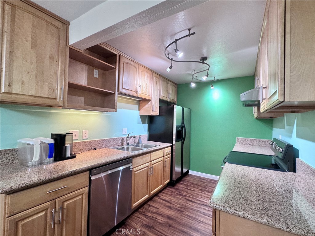 346 Miraleste Drive, Unit 301 San Pedro, CA 90732 - Photo 5 of 22 a kitchen with stainless steel appliances granite countertop a sink stove and cabinets