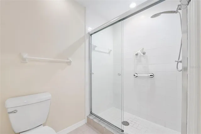 a bathroom with a shower and toilet