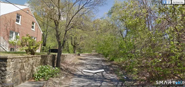 a backyard of a house with a tree