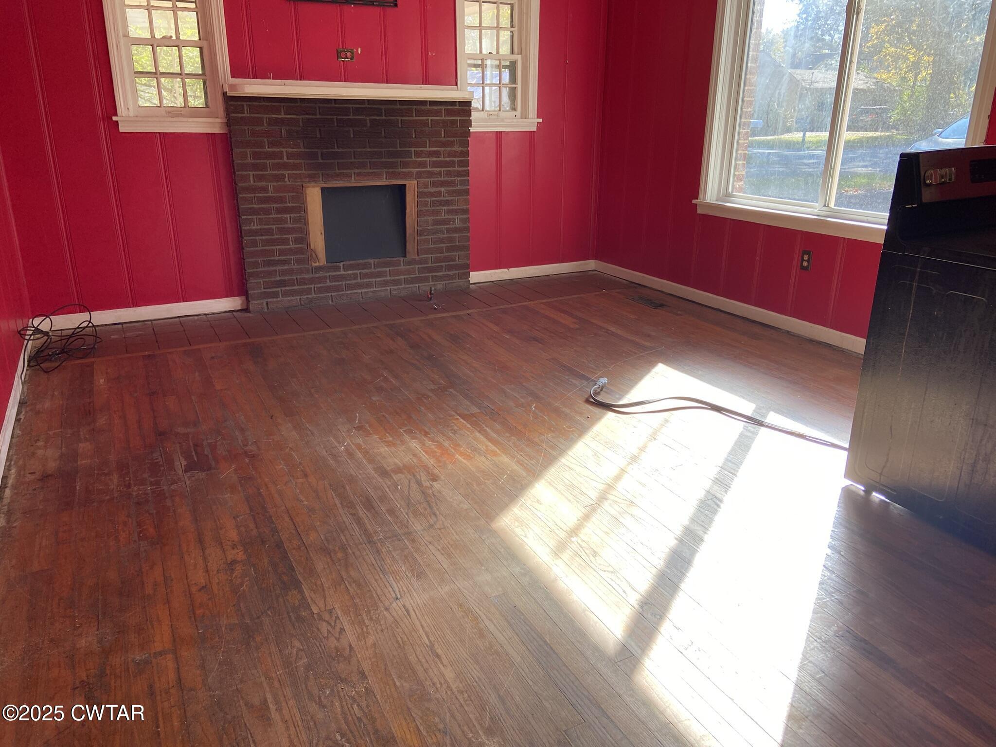 237 East 3rd Street Henderson, TN 38340 - Photo 4 of 9 a view of empty room with wooden floor and fan