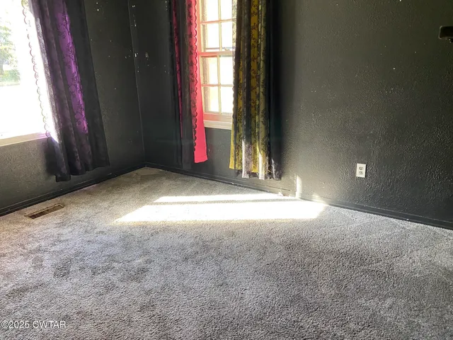 a view of empty room with windows