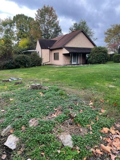 1050 Butler Road Springdale, PA 15144 - Photo 2 of 8 a front view of a house with yard and green space