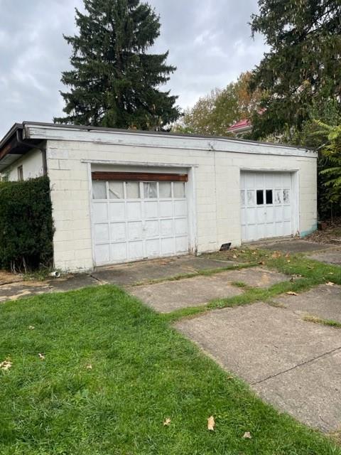 1050 Butler Road Springdale, PA 15144 - Photo 3 of 8 front view of house with a yard and trees all around