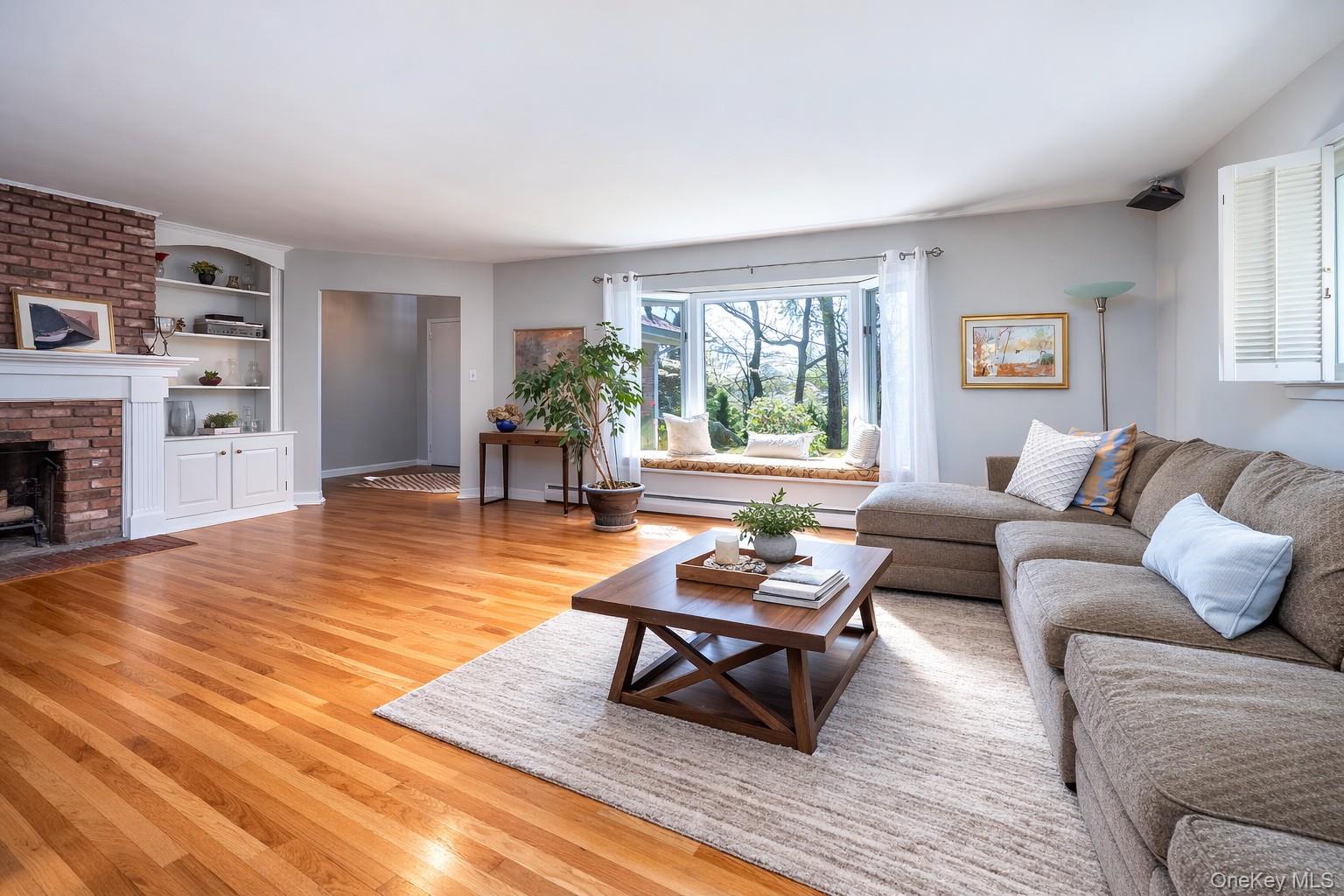 4 Knoll Top Road Stony Brook, NY 11790 - Photo 5 of 40 Living room with oak flooring and wood burning fireplace