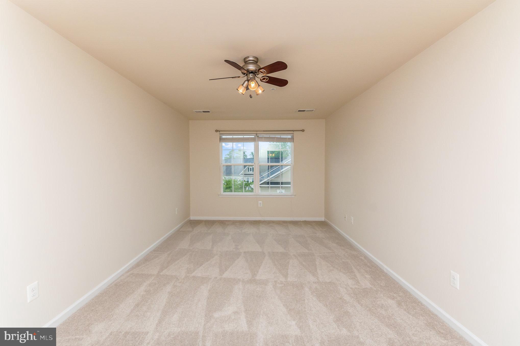 4722 Dane Ridge Circle Woodbridge, VA 22193 - Photo 11 of 28 an empty room with windows and ceiling fan