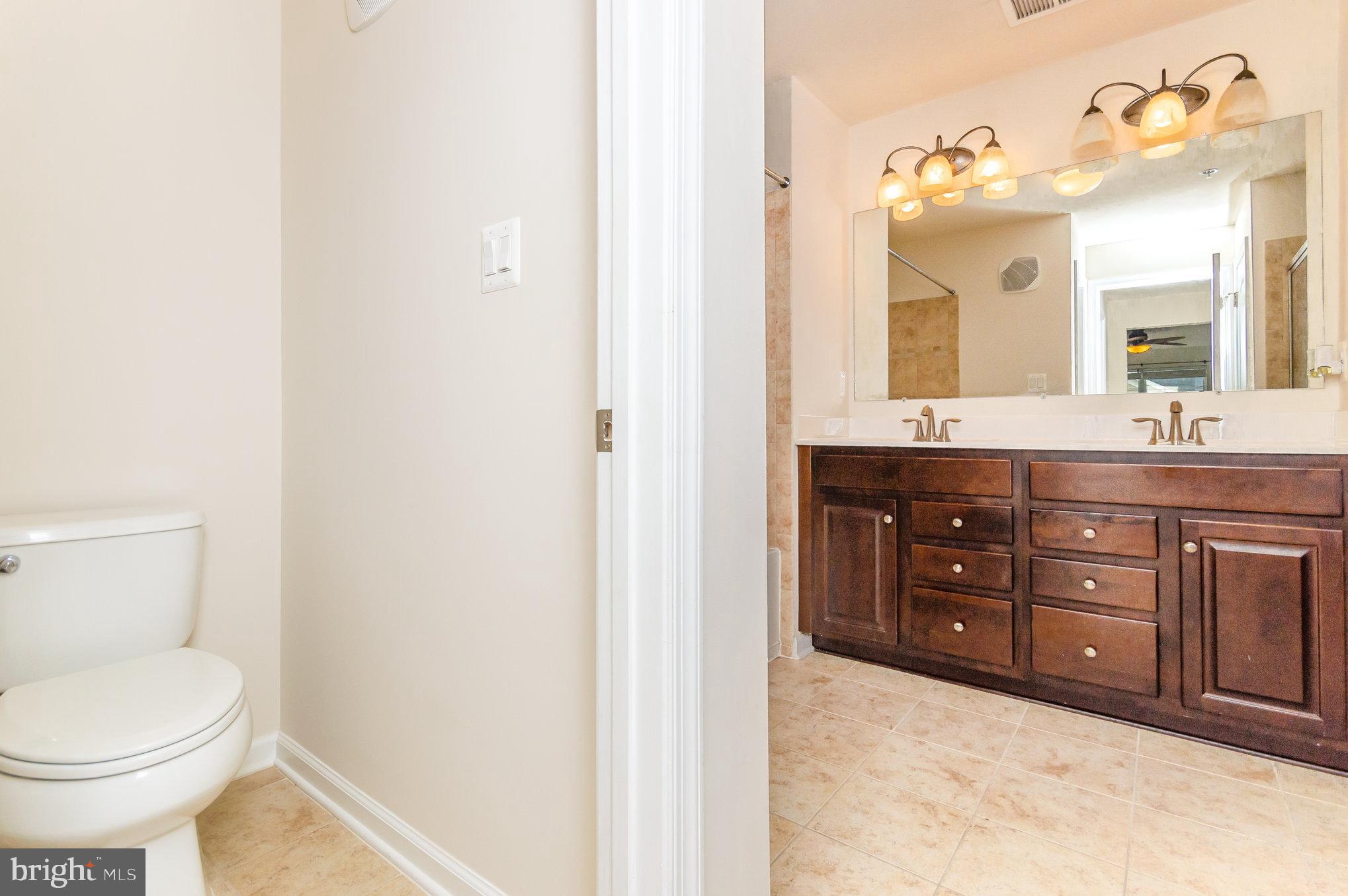 4722 Dane Ridge Circle Woodbridge, VA 22193 - Photo 13 of 28 double vanity with a granite countertop toilet sink and mirror