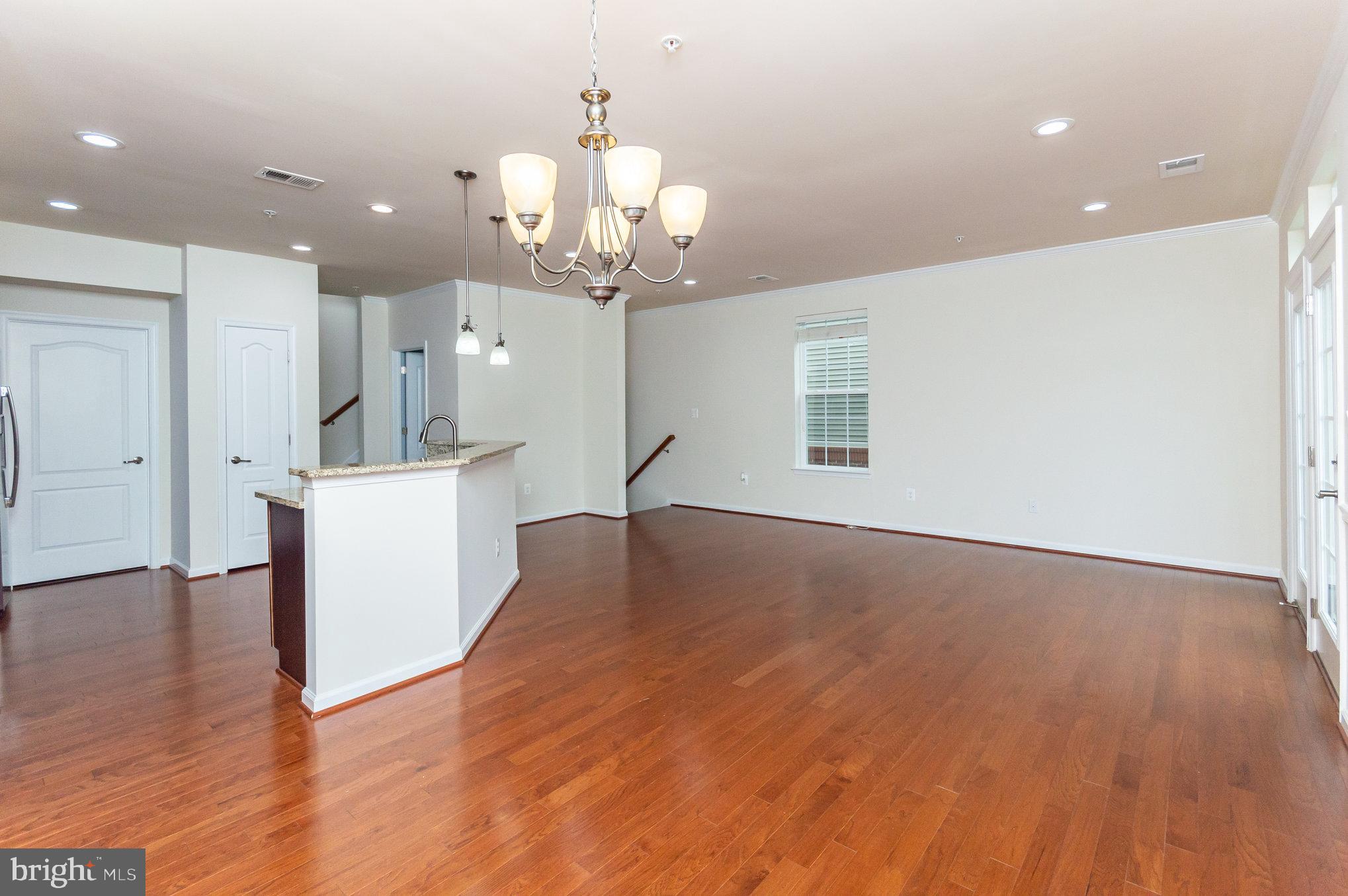 4722 Dane Ridge Circle Woodbridge, VA 22193 - Photo 4 of 28 a view of a room with wooden floor and kitchen view