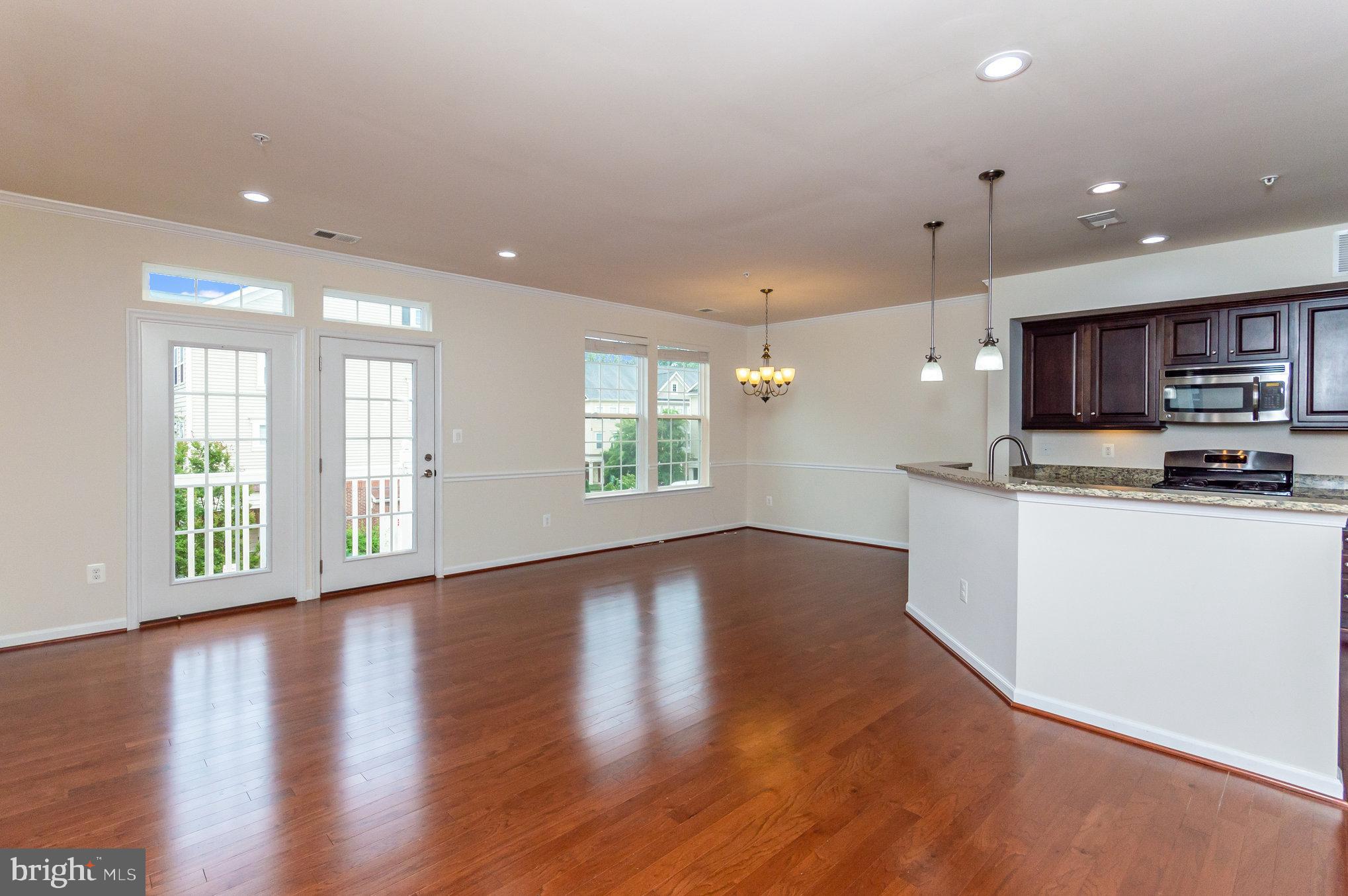 4722 Dane Ridge Circle Woodbridge, VA 22193 - Photo 5 of 28 a view of kitchen with kitchen island granite countertop a stove top oven a sink and a wooden floors