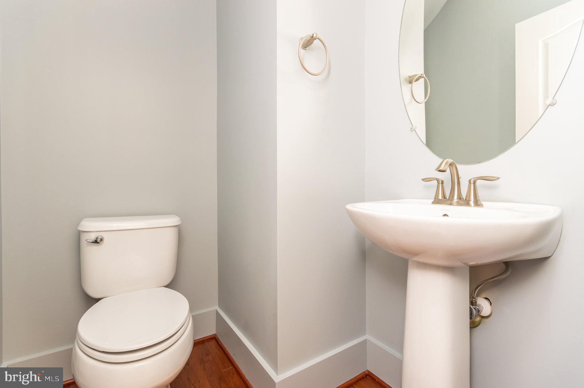 4722 Dane Ridge Circle Woodbridge, VA 22193 - Photo 10 of 28 a bathroom with a toilet sink and mirror